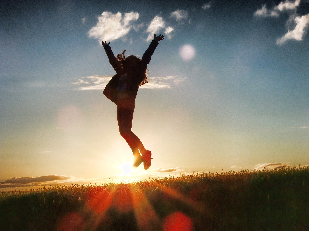 A person jumping in the air with their arms outstretched.